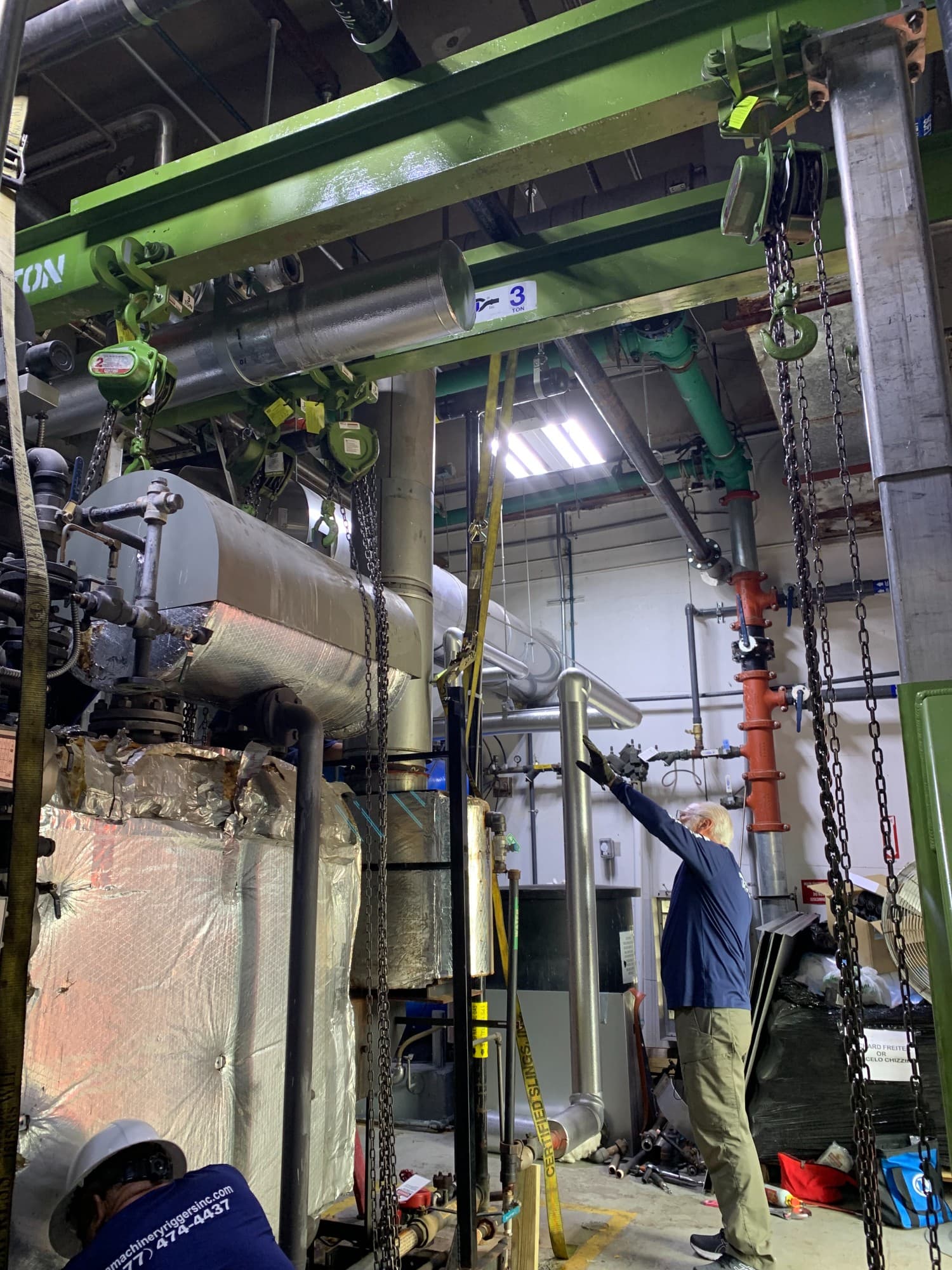 Industrial machinery rigging operation in a manufacturing facility